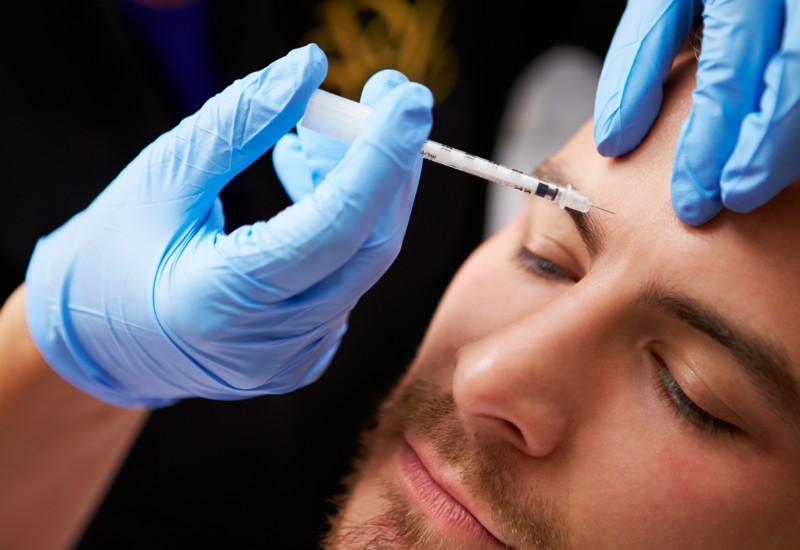 man getting botox, to his eyebrows