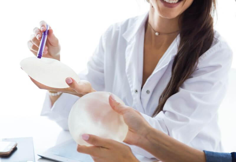doctors holding breast implants