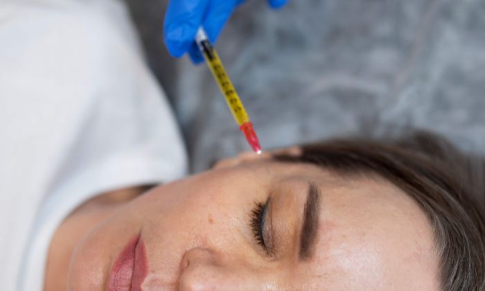 Aesthetic specialist performing a skin tightening injection treatment on a patient’s jawline to reduce double chin.