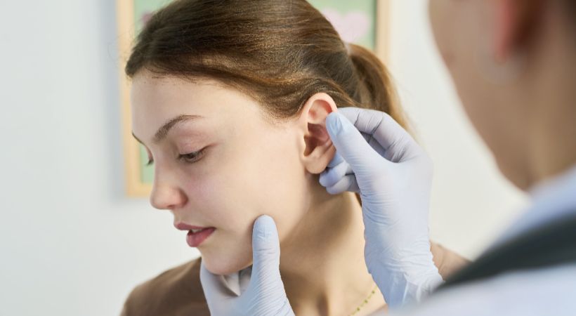 woman being examined for ear pinning surgery