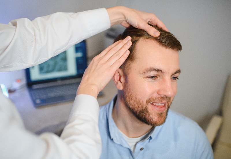 Man receiving hair transplant treatment